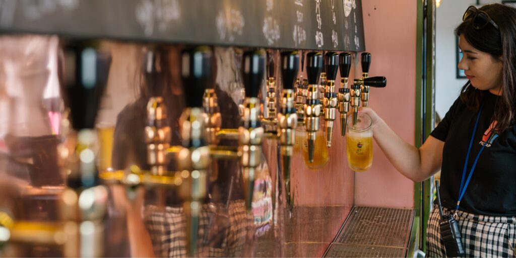 A photo of a staff member pouring a pint of beer