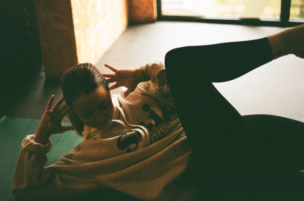 A woman doing stretches in a studio