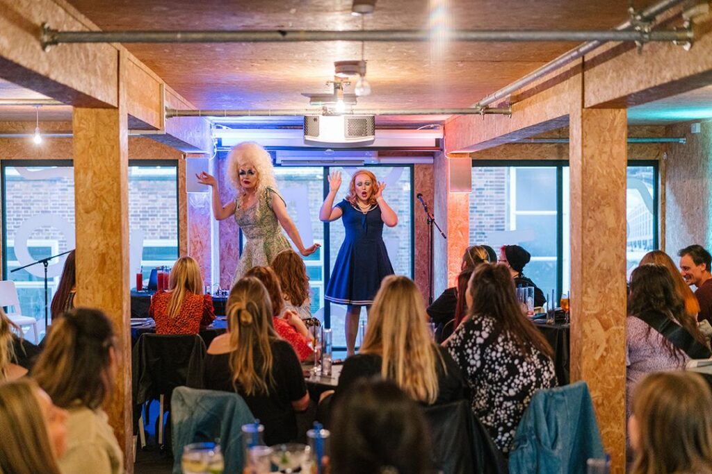 Two drag artists performing in the Show space
