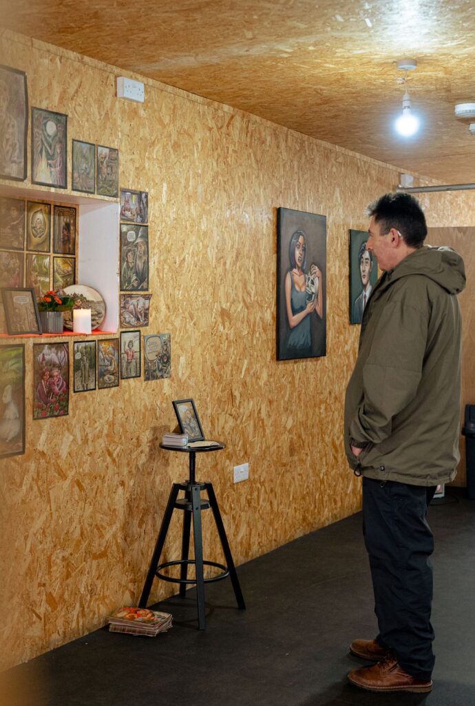 A man looking at artwork