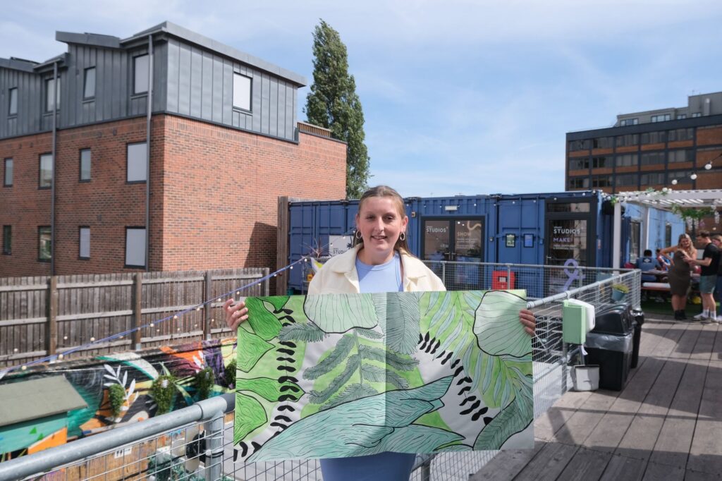 A woman holding a photo of leaves