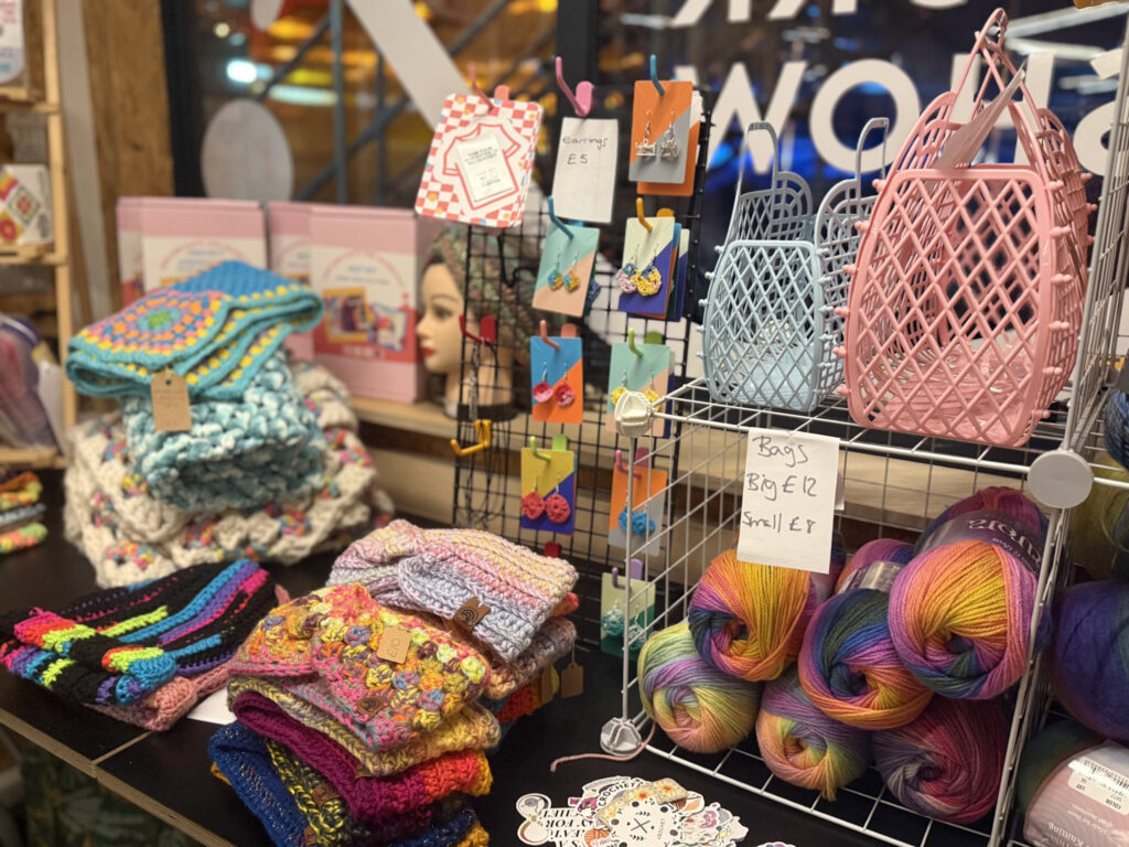 A photo of a market at SPARK with knitted products