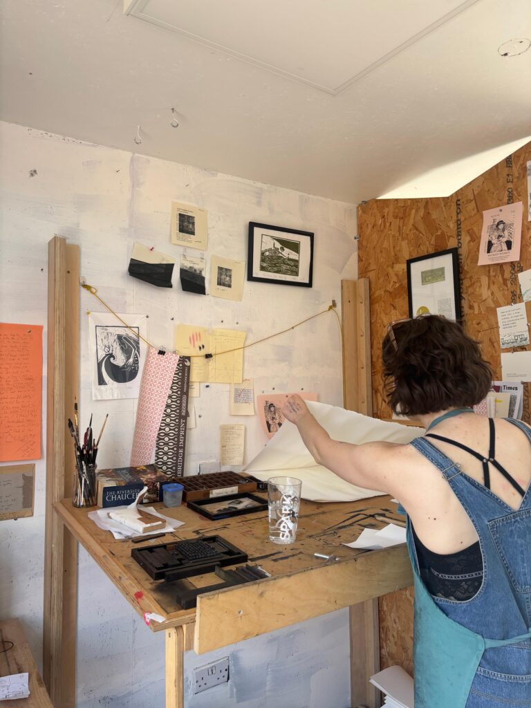 Rebecca Drake working on lino cut book
